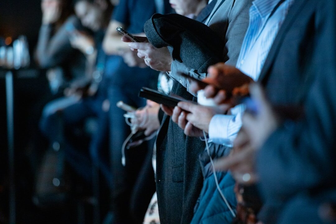 person using smartphone in crowd